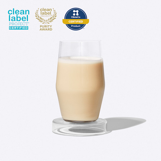 Glass of Essential Protein Daily Shake on a grey background with three certification badges