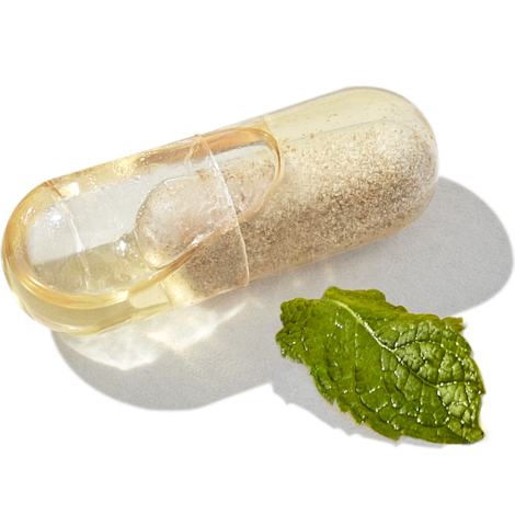 Close-up image of Essential Postnatal capsule with mint leaf