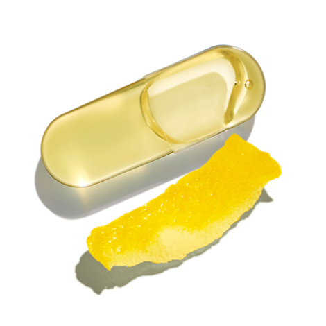 An Omega-3 DHA & EPA capsule next to a lemon rind on a transparent background.