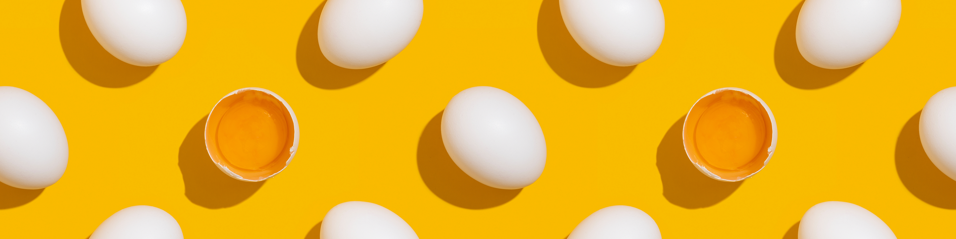 Eggs scattered on a yellow background.