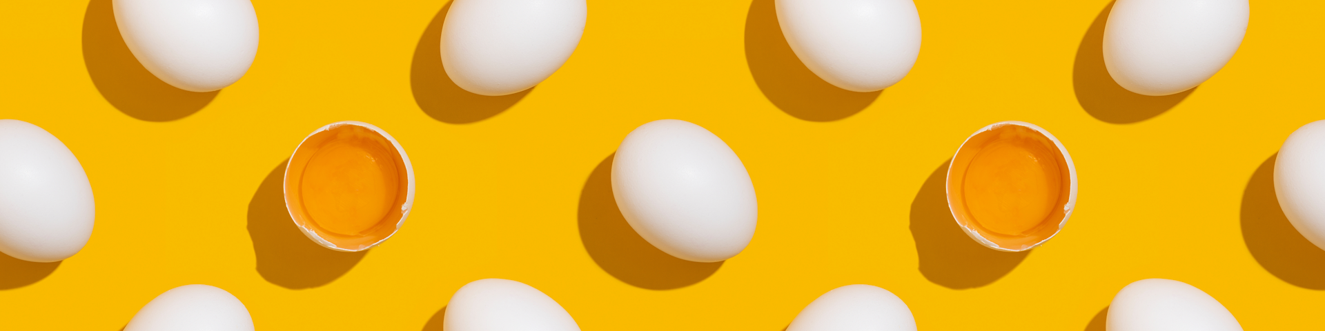 Eggs scattered on a yellow background.