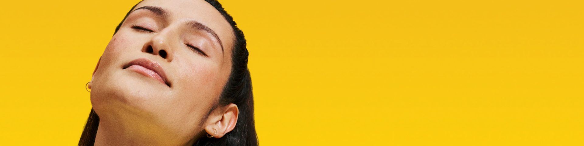 Woman with her eyes closed looking calm and relaxed.